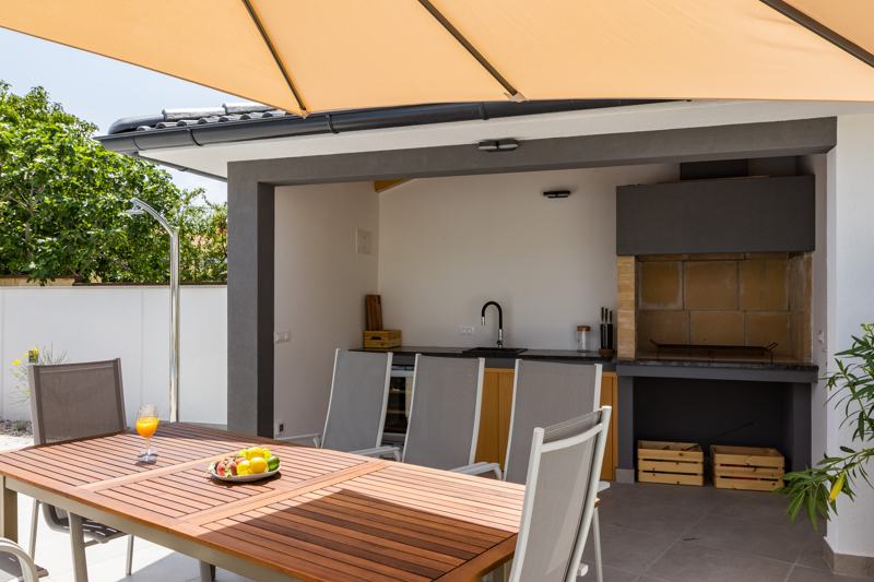 Covered outdoor kitchen with grill