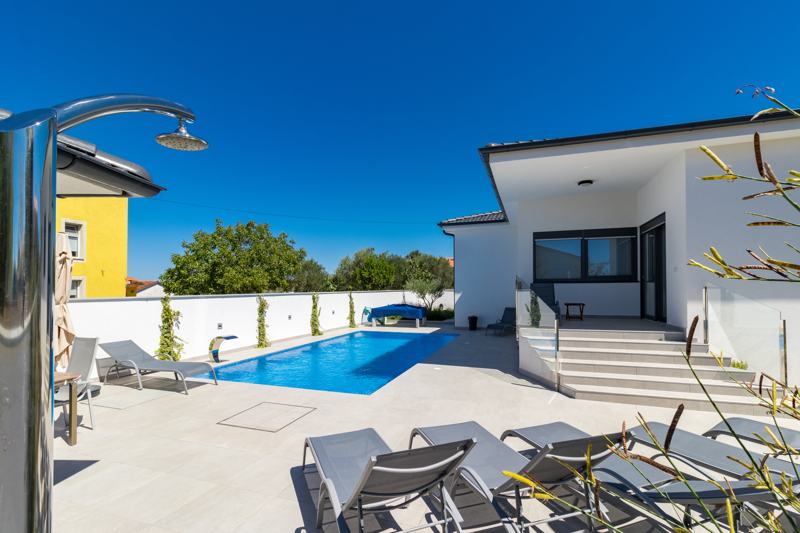 Outdoor shower and sun loungers