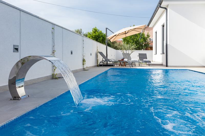 Pool with stainless steel waterfall
